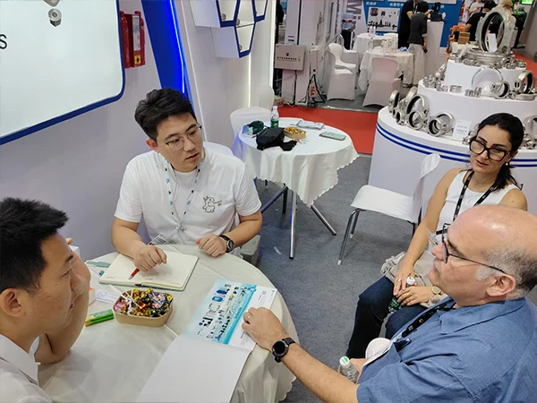 Sales staff discussing products with potential customers.