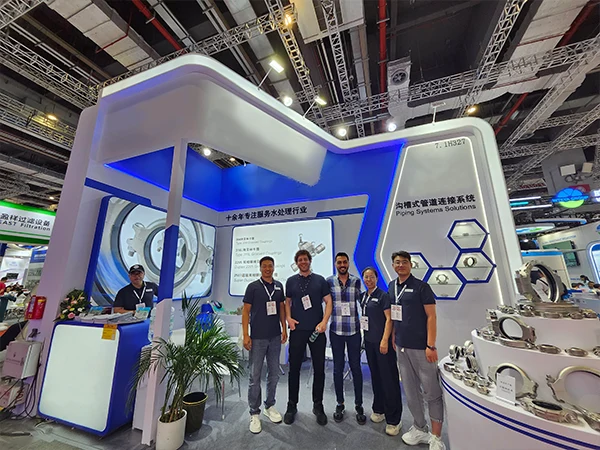 Sales team posing for a group photo with international customers at the booth