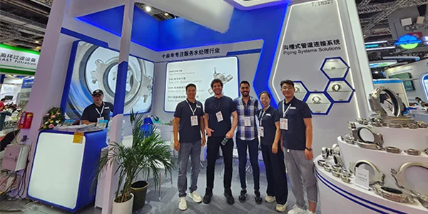 Sales team members took a group photo in front of the booth