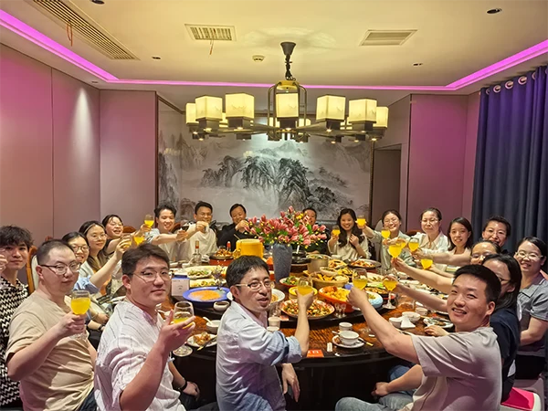 Production workshop head and sales team are having dinner together.