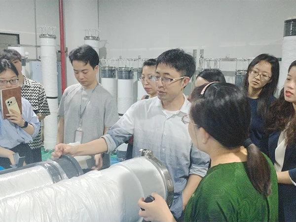 Technicians are explaining the UF membrane production process to the sales team.