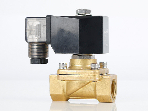 The pilot operated solenoid valve is marked with the direction of the medium flow