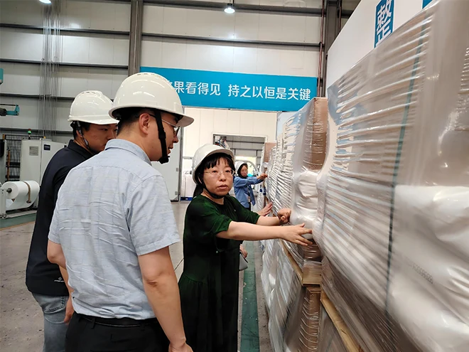 The quality inspector is carefully checking the product packaging.