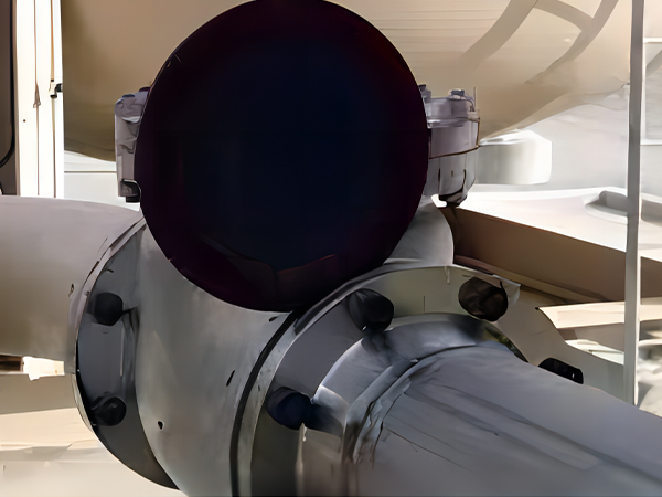 The spectacle blind is located in the open position to allow fluid to pass through the pipeline.