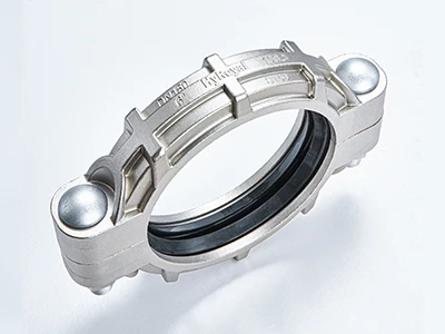 A piece of S160 stainless steel flexible grooved coupling on white background