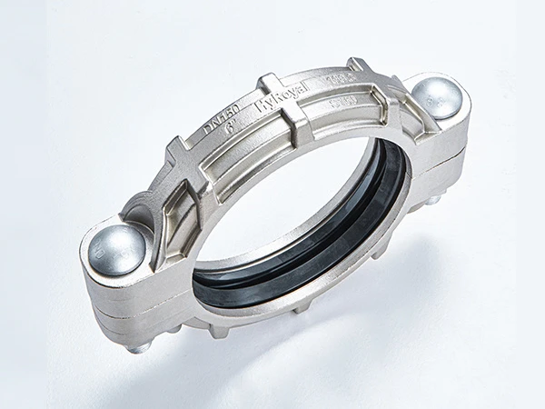 A piece of S160 stainless steel flexible grooved coupling on white background