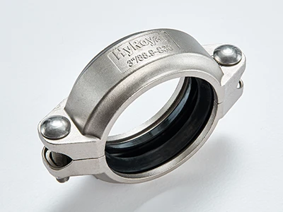 A piece of S30 stainless steel flexible grooved coupling on white background
