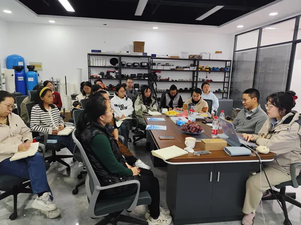 Participants engaging in indoor UV water sterilizer training and discussions.